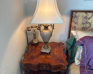Castilian Urn lamp with shade 40” with finial                                        Maitland Smith End table with drawers and pull outs. 25" H X 24" A 24"                                                                           Sitel Brass Phone                                                                                      