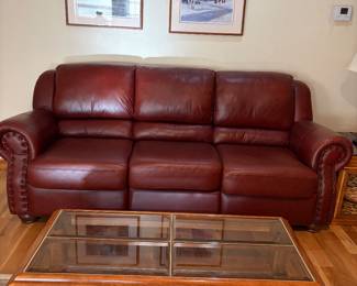 Lovely Contemporary Leather Sofa. Solid Wood and glass coffee table on wheels for easy moving 