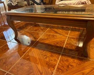 Oversized coffee table which also matches the couches.  The glass top has beautiful etching in it