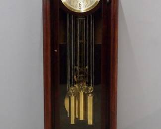 An early 20th century Jacques hall clock retailed by Cowell & Hubbard, Cleveland, O.  8-day weight driven movement with quarter hour chiming on six tubular bells, circular Silvered dial with engraved detail and Arabic numerals, subsidiary seconds dial, "Silent/Hour Str", "Silent/Chime" and "Westminster/Trinity" selection levers, Bi-metallic lyre pendulum, serial #240393.  Mahogany Neoclassical style case with an arched, molded crown over a single arched door frame flanked by turned columns on a stepped plinth base with flattened bun feet.  Older finish with minor wear, running when cataloged.  75 1/2" high overall.  ESTIMATE $2,000-3,000