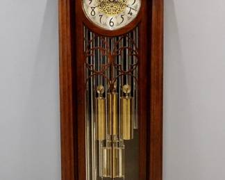 A 20th century Herschede hall clock.  8-day weight driven movement with quarter hour chiming on nine tubular bells, arched Brass dial with engraved filigree design and Arabic numerals, subsidiary seconds dial, "Silent/Strike", "Whittington, Canterbury/Westminster" and "Chime/Silent" selection levers, Faux Mercury pendulum, serial #45571.  Mahogany Gothic Revival style case with an arched, molded crown over a single arched door frame flanked by fluted columns on a stepped plinth base.  Older finish with minor wear, running when cataloged.  79" high overall.  ESTIMATE $1,000-2,000