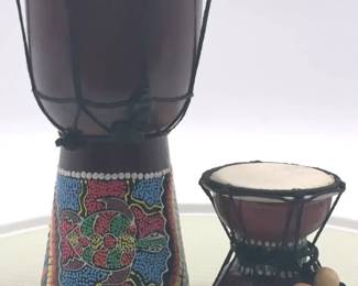 A pair of decorative Africanstyle hand drums with painted motifs.