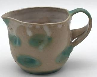 Handmade studio pottery creamer with green glaze accents