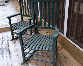 Two green wooden rocking chairs