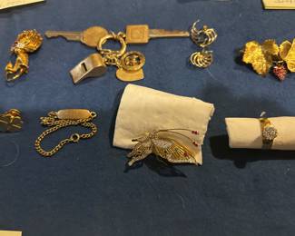 18k gold lion pin, 14k gold key chain with 2 keys, whistle, 2 charms and a key ring; pair of aqua and 14k gold earrings, 18k gold pin with 2 leaves and a ruby strawberry, 14k gold four leaf clover tie tack, 14k gold butterfly pin, 10k gold ring with 7 .01 diamonds