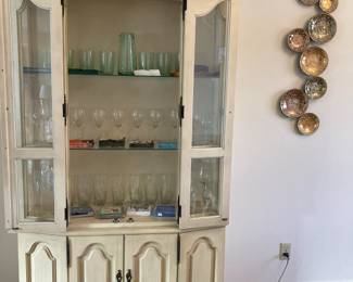 Glass ware and napkins inside hutch