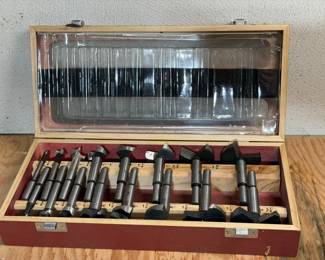 15-piece Forstner drill bit set in a wooden storage cas
