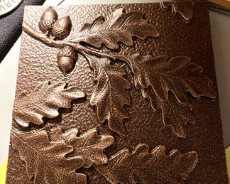 Signed oak leaf/acorn motif iron plaque (2)