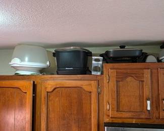 Kitchen full of cookware. Crock pots, cookers, waffle makers, deli slicers, and more.