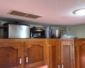 Kitchen full of cookware. Crock pots, cookers, waffle makers, deli slicers, and more.