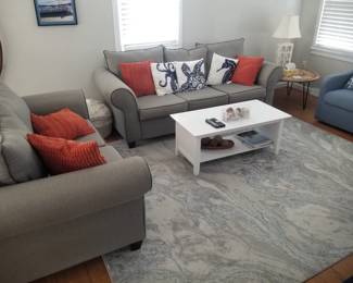 Lovely living room furnishings: couch, loveseat. coffee table, rug