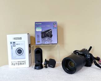 Fujifilm FinePix T190 camera. Canary Flex indoor/outdoor security camera. GoPro Hero5 session action camera. Lomography Lomo'Instant Automat Camera. Nikon D5000 DSLR camera