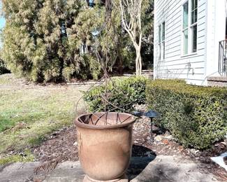 Metal garden obelisk trellis in a large ceramic pot