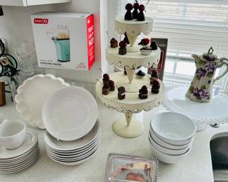 Great Kitchen Ware Available Includes Royal Norfolk Set of 8 Soup Bowls, a Dash Popcorn Maker in Mint Green, a Whimsical 3 Tier Vintage Galvanized Steel Cake stand Adorned with Faux Treats, Corningware White Bowls, a Nippon Porcelain Chocolate Pot on a Vintage Fenton Ruffled Cake Plate.