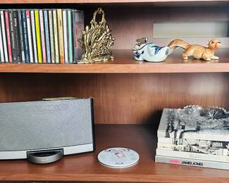 Part of the Great CD Collection Available Shown with a Vintage 1960's Brass Filigree Cherub Letter/Napkin Holder, a Delft Lighter, Bose SoundDock Portable Music System N123 and Several Volumed of the World War II Book Series by Time Life.