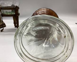 VINTAGE AMBER CANDY DISH WITH GOLD GILT, GOLD TONE PINEAPPLE COASTERS, GERMAN KUNDO BATTERY POWERED QUARTZ CLOCK, DABS OIL LAMP AND BRASS FOOTED PILLAR CANDLE HOLDER