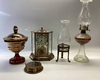 VINTAGE AMBER CANDY DISH WITH GOLD GILT, GOLD TONE PINEAPPLE COASTERS, GERMAN KUNDO BATTERY POWERED QUARTZ CLOCK, DABS OIL LAMP AND BRASS FOOTED PILLAR CANDLE HOLDER