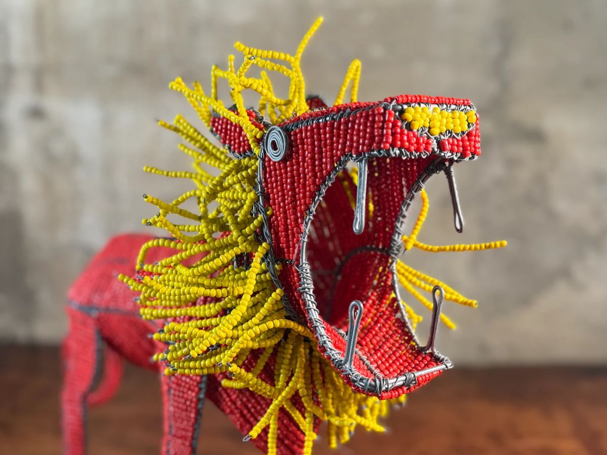 This lot features a folk art beaded wire sculpture that measures, 16” H x 19” W x 7” D.

