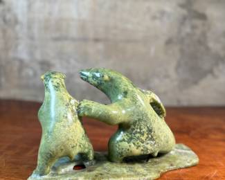 This lot features a tandem bear Inuit carving, signed in Inuitituk syllabic and dated 1996.  This piece was purchased in Cape Dorset/Kinngait, directly from the artist by collector Jon Jacobs, a prominent collector of Inuit art. One of the bears is missing his arm. Otherwise excellent condition. This piece measures, 6” H x 11” W x 5” D.

