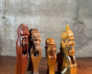 This lot features a collection of four (4) hand-carved wooden figural nutcrackers, likely made in the Black Forest region of Germany or Switzerland. These antique folk art pieces generally date back to the late 19th century or early 20th century. The tallest measures, 10” H.

