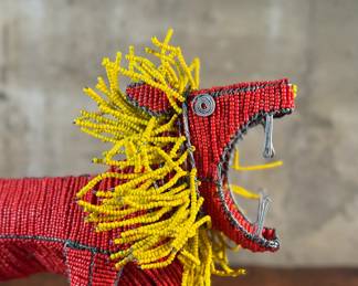 This lot features a folk art beaded wire sculpture that measures, 16” H x 19” W x 7” D.

