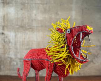 This lot features a folk art beaded wire sculpture that measures, 16” H x 19” W x 7” D.

