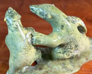 This lot features a tandem bear Inuit carving, signed in Inuitituk syllabic and dated 1996.  This piece was purchased in Cape Dorset/Kinngait, directly from the artist by collector Jon Jacobs, a prominent collector of Inuit art. One of the bears is missing his arm. Otherwise excellent condition. This piece measures, 6” H x 11” W x 5” D.

