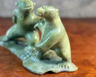 This lot features a tandem bear Inuit carving, signed in Inuitituk syllabic and dated 1996.  This piece was purchased in Cape Dorset/Kinngait, directly from the artist by collector Jon Jacobs, a prominent collector of Inuit art. One of the bears is missing his arm. Otherwise excellent condition. This piece measures, 6” H x 11” W x 5” D.

