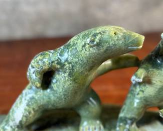 This lot features a tandem bear Inuit carving, signed in Inuitituk syllabic and dated 1996.  This piece was purchased in Cape Dorset/Kinngait, directly from the artist by collector Jon Jacobs, a prominent collector of Inuit art. One of the bears is missing his arm. Otherwise excellent condition. This piece measures, 6” H x 11” W x 5” D.

