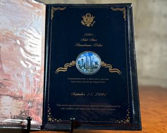 This lot features a 2001 Solid Silver Remembrance Dollar, containing one (1) troy ounce of .999 fine silver. It is a United States commemorative coin minted in 2001.

