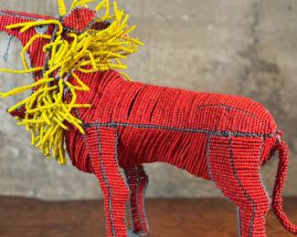 This lot features a folk art beaded wire sculpture that measures, 16” H x 19” W x 7” D.

