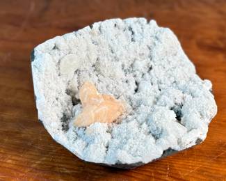 This lot features a stunning Peach Stilbite cluster on a White Zeolite matrix. This specimen measures, 3.5” H x 8.5” W x 8” D. A "Peach Stilbite Cluster on White Zeolite Matrix" is a beautiful natural mineral specimen featuring delicate, radiating blades of peach-colored stilbite (a zeolite) growing on a contrasting white mineral matrix, often basalt or heulandite, typically from India, prized by collectors for its visual appeal and believed gentle, calming energies for spiritual growth.

