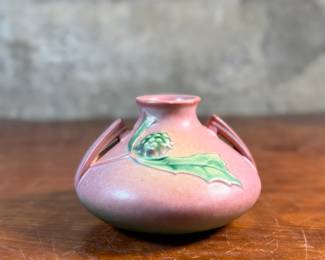 This lot features a Roseville Pottery "Thornapple" vase in a pink glaze that measures, 4.5” H x 6.5” W x 6.5” D. It comes in very good condition and is marked, "808-4" on the bottom. The Thornapple pattern was introduced by Roseville Pottery in 1937.

