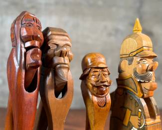 This lot features a collection of four (4) hand-carved wooden figural nutcrackers, likely made in the Black Forest region of Germany or Switzerland. These antique folk art pieces generally date back to the late 19th century or early 20th century. The tallest measures, 10” H.

