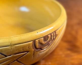 This lot features an antique bowl by Weller Pottery in their "Paragon" pattern, dating to the late 1920s. This bowl measures, 3.25” H x 9.75” W x 9.75” D. The Paragon line, introduced in 1931, is known for its woodcut-like floral motif, which is consistent with the design on your bowl. There is one very small hairline crack shown in photos.

