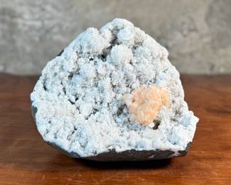 This lot features a stunning Peach Stilbite cluster on a White Zeolite matrix. This specimen measures, 3.5” H x 8.5” W x 8” D. A "Peach Stilbite Cluster on White Zeolite Matrix" is a beautiful natural mineral specimen featuring delicate, radiating blades of peach-colored stilbite (a zeolite) growing on a contrasting white mineral matrix, often basalt or heulandite, typically from India, prized by collectors for its visual appeal and believed gentle, calming energies for spiritual growth.

