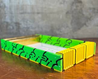 "Box 26", an original mixed media work of art by listed artist, Howard Hack circa 1995. This piece measures, 2.5” H x 18” W x 10.5” D. Howard Edwin Hack (July 6, 1932 – June 11, 2015) was an American representational painter and graphic artist, with works in numerous museum collections. Known for an innovative approach to a variety of media, as well as use of traditional oil paints, Hack began working in the late 1940s.

