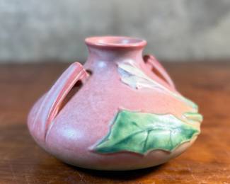 This lot features a Roseville Pottery "Thornapple" vase in a pink glaze that measures, 4.5” H x 6.5” W x 6.5” D. It comes in very good condition and is marked, "808-4" on the bottom. The Thornapple pattern was introduced by Roseville Pottery in 1937.

