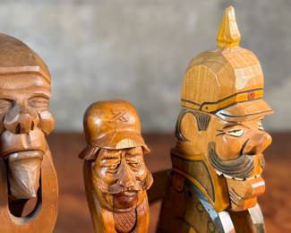This lot features a collection of four (4) hand-carved wooden figural nutcrackers, likely made in the Black Forest region of Germany or Switzerland. These antique folk art pieces generally date back to the late 19th century or early 20th century. The tallest measures, 10” H.

