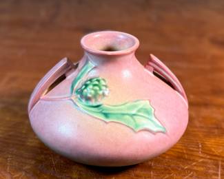 This lot features a Roseville Pottery "Thornapple" vase in a pink glaze that measures, 4.5” H x 6.5” W x 6.5” D. It comes in very good condition and is marked, "808-4" on the bottom. The Thornapple pattern was introduced by Roseville Pottery in 1937.

