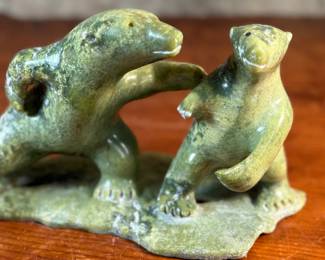 This lot features a tandem bear Inuit carving, signed in Inuitituk syllabic and dated 1996.  This piece was purchased in Cape Dorset/Kinngait, directly from the artist by collector Jon Jacobs, a prominent collector of Inuit art. One of the bears is missing his arm. Otherwise excellent condition. This piece measures, 6” H x 11” W x 5” D.


