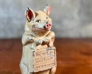 This lot features a J.M.R. Hubley No. 82 cast iron “Thrifty Wise Pig” piggy bank that measures, 6.5” H.

