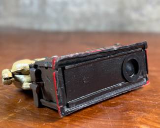 This lot features a reproduction cast iron mechanical bank known as the "Trick Pony". This bank measures, 7” H x 7” W x 2.5” D. The bank was originally patented in 1885 by Juleus Mueller, with manufacturing rights assigned to Charles and Walter Shepard. To operate the bank, a coin is placed in a small trough on the left, and a lever is pulled. 

