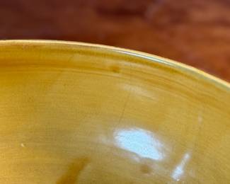 This lot features an antique bowl by Weller Pottery in their "Paragon" pattern, dating to the late 1920s. This bowl measures, 3.25” H x 9.75” W x 9.75” D. The Paragon line, introduced in 1931, is known for its woodcut-like floral motif, which is consistent with the design on your bowl. There is one very small hairline crack shown in photos.

