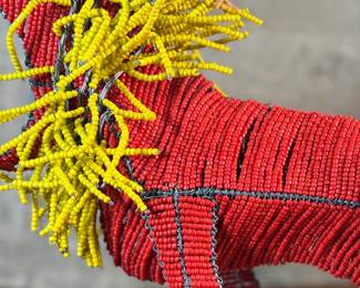 This lot features a folk art beaded wire sculpture that measures, 16” H x 19” W x 7” D.

