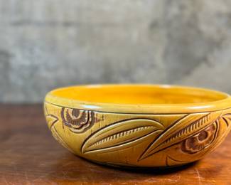 This lot features an antique bowl by Weller Pottery in their "Paragon" pattern, dating to the late 1920s. This bowl measures, 3.25” H x 9.75” W x 9.75” D. The Paragon line, introduced in 1931, is known for its woodcut-like floral motif, which is consistent with the design on your bowl. There is one very small hairline crack shown in photos.

