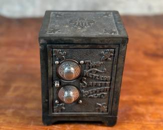 This lot features an antique cast iron bank known as, “The Keyless Safety Deposit Box”. Locks and unlocks as it should and measures, 6” H x 4.5” W x 4” D.

