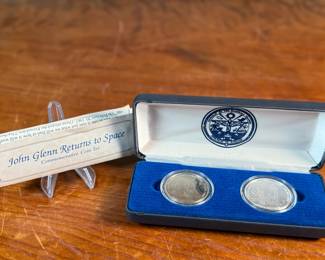 This lot features a John Glenn Returns to Space Commemorative Coin Set that includes a $50 .999 fine silver coin, along with a $5 solid cupronickel coin, circa 1998. Comes in the original presentation case with a certificate of authenticity. It commemorates John Glenn’s historic 1998 space shuttle flight aboard the Discovery (STS-95), when he became the oldest person to fly in space. 


