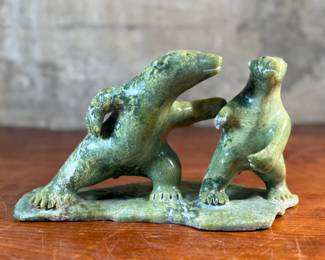 This lot features a tandem bear Inuit carving, signed in Inuitituk syllabic and dated 1996.  This piece was purchased in Cape Dorset/Kinngait, directly from the artist by collector Jon Jacobs, a prominent collector of Inuit art. One of the bears is missing his arm. Otherwise excellent condition. This piece measures, 6” H x 11” W x 5” D.

