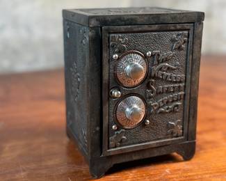 This lot features an antique cast iron bank known as, “The Keyless Safety Deposit Box”. Locks and unlocks as it should and measures, 6” H x 4.5” W x 4” D.

